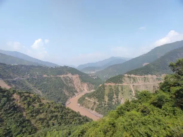 Photo of Monsoon river flowing through Mountains of Himalayas in India