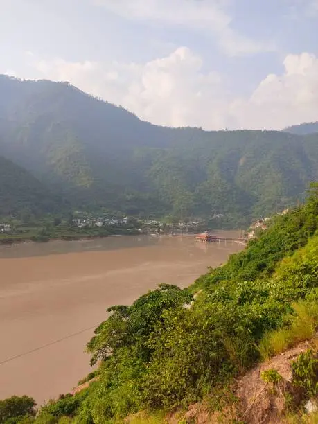 Photo of Monsoon river flowing through Mountains of Himalayas in India