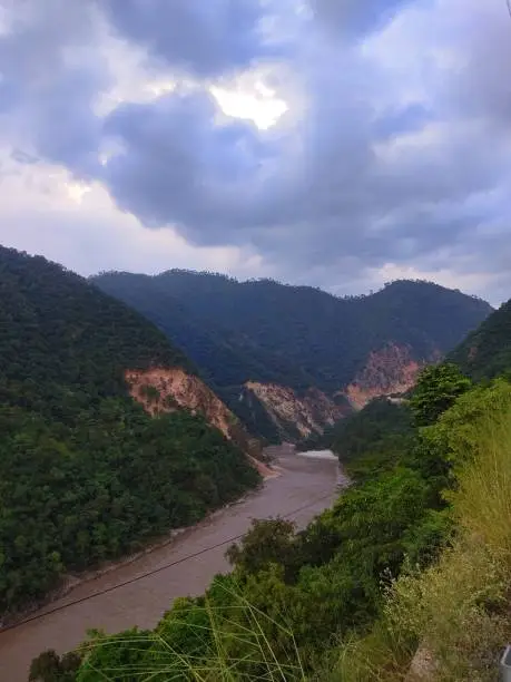 Photo of Monsoon river flowing through Mountains of Himalayas in India