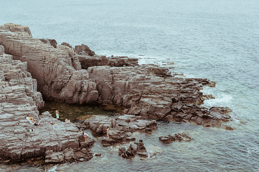 San Pietro Island, Sardinia (Italy). August 3, 2020. Some tourists walk on the cliff overlooking the sea