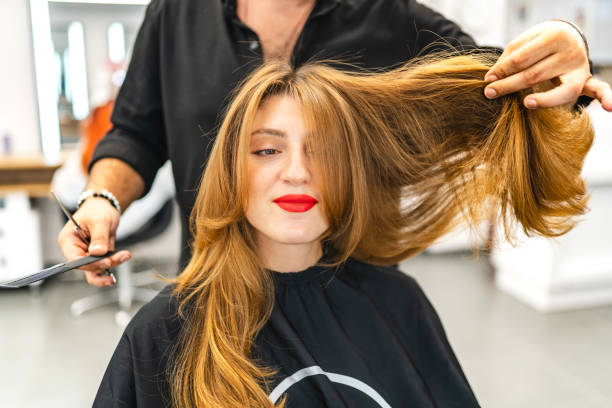 beautiful young woman getting her hair cut - red hair hairstyle dyed hair women imagens e fotografias de stock