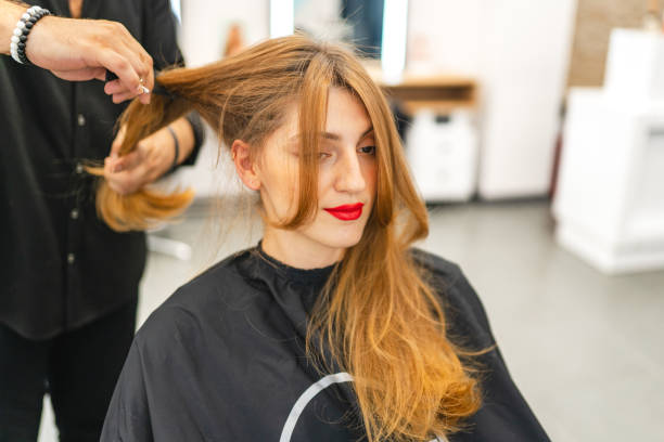 istock Beautiful young woman getting her hair cut 1678702802