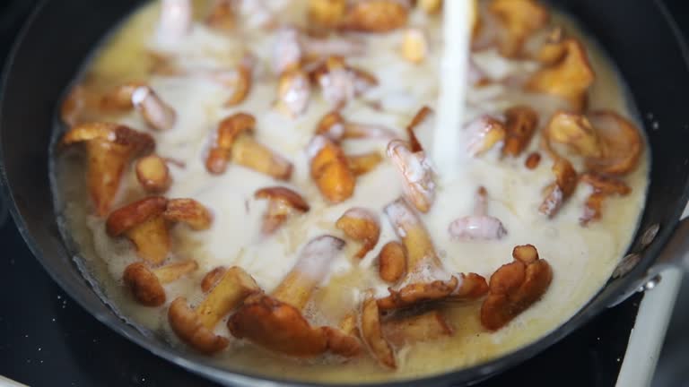 chanterelles cream sauce mushrooms fried adding food appetizer meal food snack on the table copy space