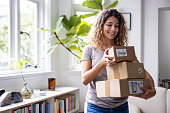 Happy woman at home receiving packages in the mail