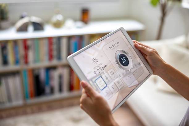 istock Woman using an automated system in her smart home to change the temperature 1678741977