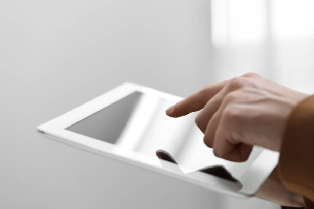 istock Closeup view of woman using modern tablet on blurred background 1678753472