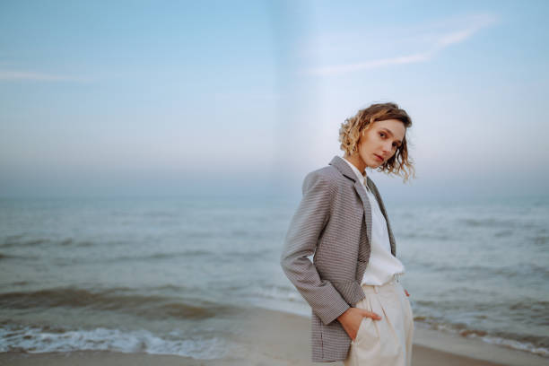 istock Stylish woman posing on autumn beach in wild grass. 1678759575