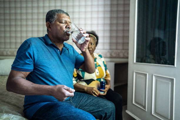 istock Senior man taking medicine at home 1678763965