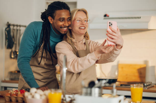 istock A happy multiethnic couple is having a video call while cooking food 1678773751