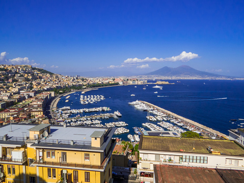 City aerial view with the Mount Vesuvius in the background. In Naples, Italy