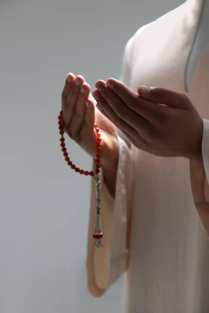 istock Muslim man with misbaha praying on blurred background, closeup 1678838319