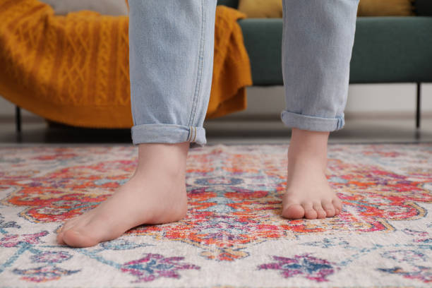 istock Woman standing on carpet with pattern in room, closeup 1678838333