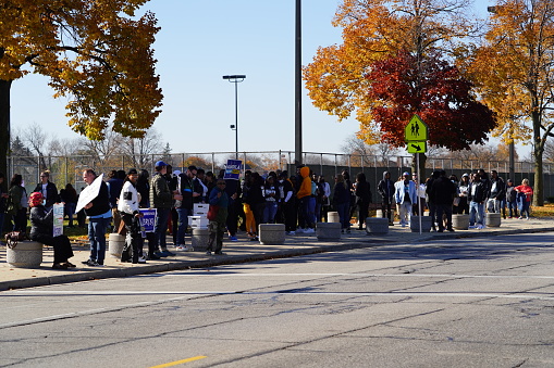 Milwaukee, Wisconsin USA - October 29th, 2022: Many Democrat voters lined up at North Division High school to participate at Governor Tony Evers, Mandela Barnes and Barack Obama Democratic party rally.