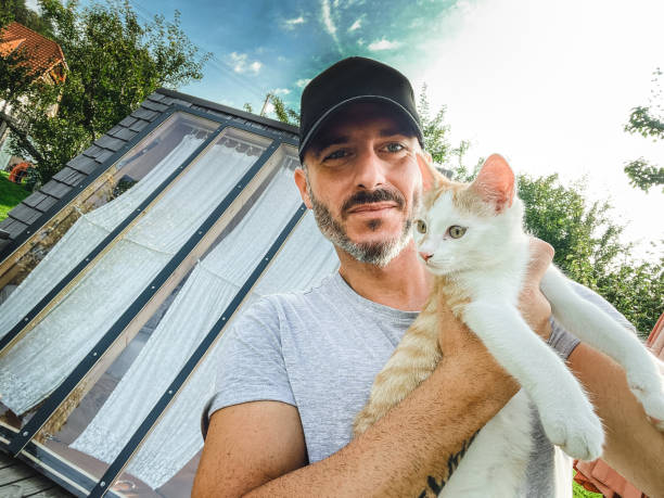 istock man take a selfie with a white and brown cat 1678925905