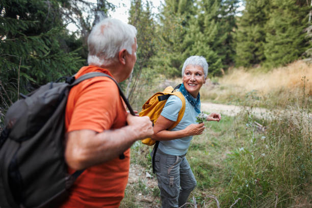 istock Senior couple hiking together in forest 1678932553