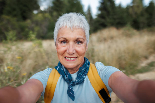 istock Smiling senior woman taking selfie while enjoying her day in nature 1678932629