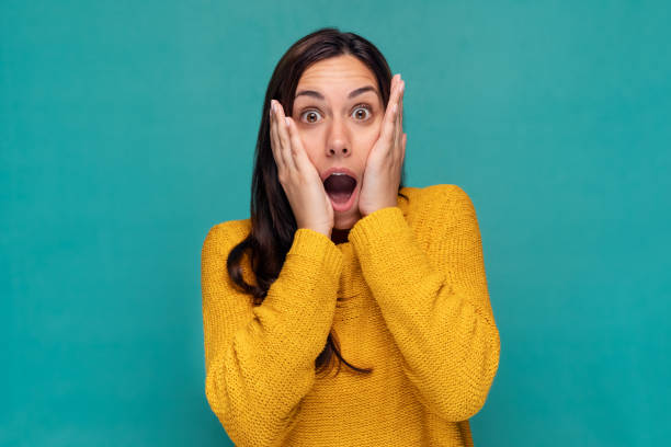 Free Stock Photo of A young woman surprised by something in a studio ...