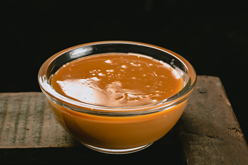 glass bowls with Argentine dulce de leche with dark background