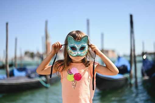 portrait of a cute little girl with Venetian mask.