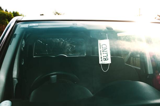 istock Car with 'We Are Not Blind' on a Blindfold made from a Face Mask 1678955675