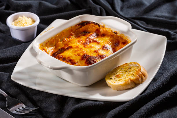 istock Delicious square hot homemade Italian lasagna - Rustic background 1679002469