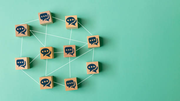 istock Concept of online communication or social networking. Wooden cubes with speech bubbles linked to each other with lines. 1679012970