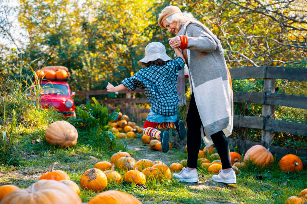 istock Girl playing with grandma in pumpkin patch 1679054875
