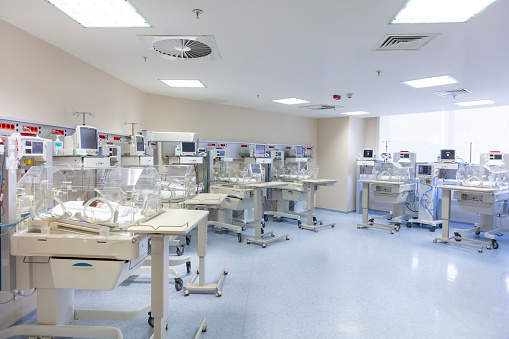 Babies and nurse in a special baby care unit.
Newborn. special care. Intensive care department. Babies in the incubator.