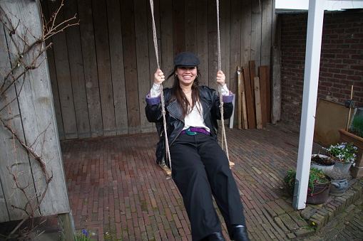 Young woman on swing on a Sunday afternoon