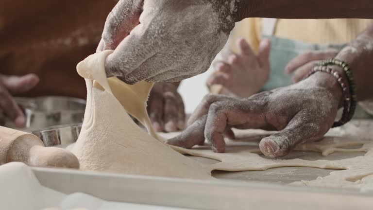 Hands of Family Preparing Homemade Cookies Together