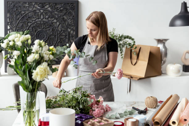 istock Female florist working with flowers 1679128019