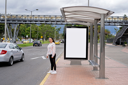Billboard at a bus stop on the street in the city of bogota. Advertising light box in white