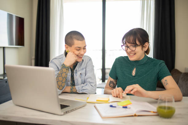 istock Two happy friends are learning together online 1679204092