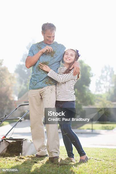 Father And Daughter Mowing Lawn Together Stock Photo - Download Image Now - 50-54 Years, 8-9 Years, Admiration