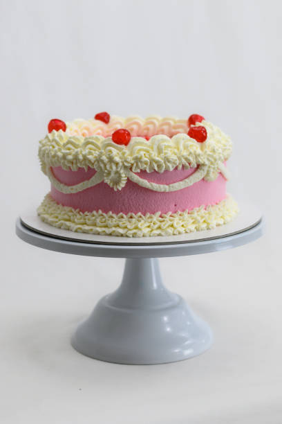 istock pink delicate cup cake with maraschino cherry for birthday celebration isolated on white 1679216568