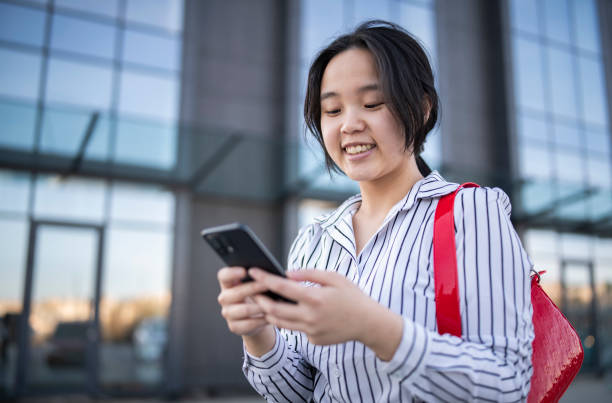 istock Asian woman using smart phone. 1679217353