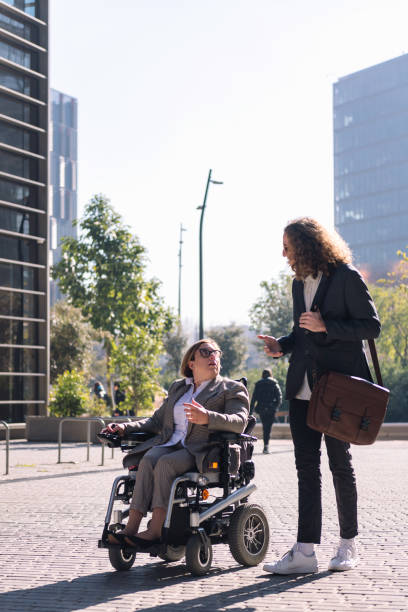 istock man and woman in wheelchair talking while walking 1679221685