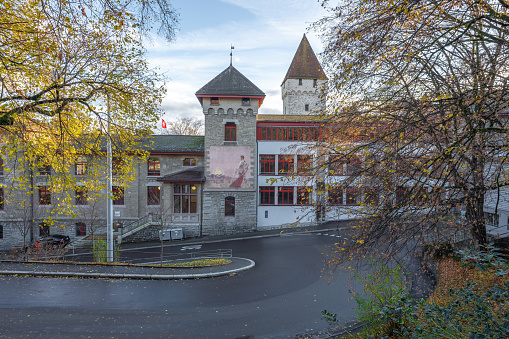 Lucerne, Switzerland - Nov 27, 2019: Former Museum of Peace and War now a public school and Dachliturm Tower - Lucerne, Switzerland