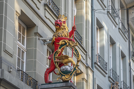Bern, Switzerland - Nov 25, 2019: Red Lion Sculpture at Mittellowen Guild House Facade - Bern, Switzerland