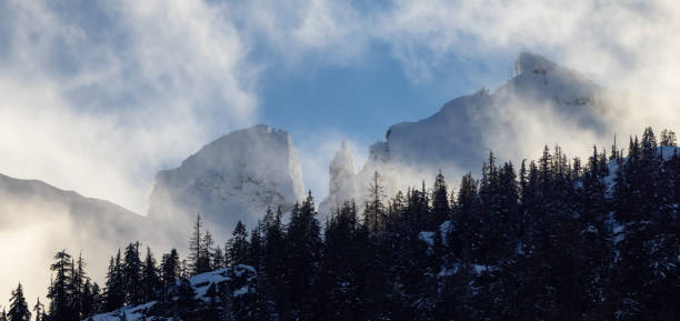 Snow and Cloud covered Canadian Nature Landscape Background. Winter Season in Squamish, British Columbia, Canada. Sunny Sky