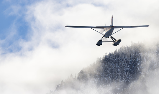 Floatplane flying over the Canadian Mountain Landscape. 3d Rendering Airplane Adventure Composite. Landscape background from Squamish, BC, Canada.