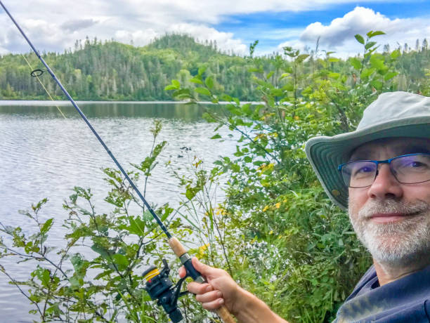istock Mature man fishing 1679357927