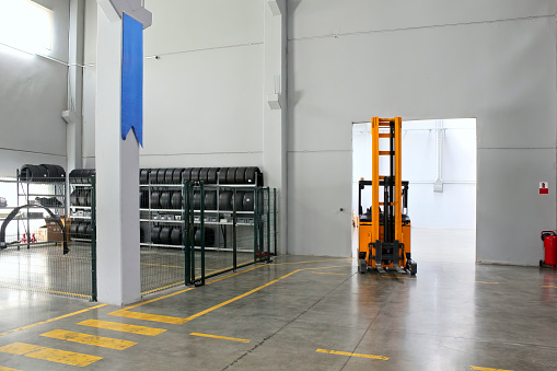 Forklift inside a warehouse of a factory building