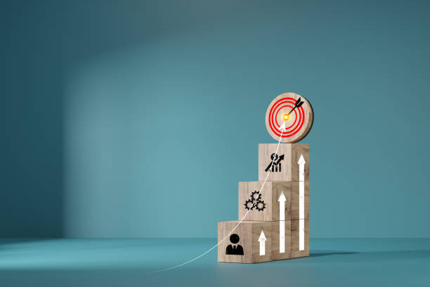 istock woods block step on table with icon Action plan. target icon on the top of wooden cube blocks. Shining rise up arrow shoot up towards the goal, business growth process. 1679409055
