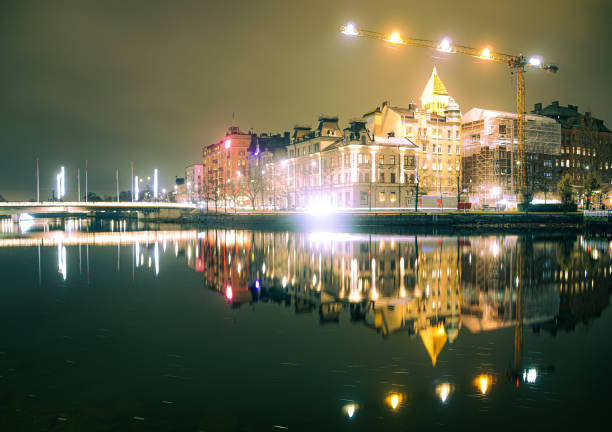 The sea sparkling in the setting sun and the skeleton of a building under construction