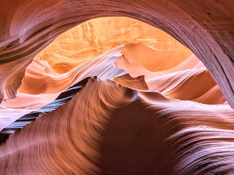 Hiker exploring the famous Wave of Coyote Buttes North in the Paria Canyon-Vermilion Cliffs Wilderness of the Colorado Plateau in southern Utah and northern Arizona USA.