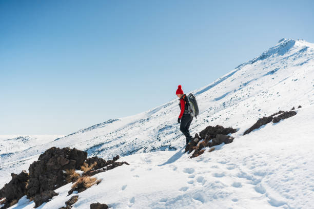 Hikers doing Tongariro crossing on a nice sunny day in Tongariro National Park, North Island, New Zealand.