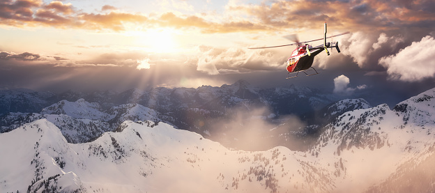 Helicopter flying over the Rocky Mountains during a colorful sunset. Aerial Landscape from BC, Canada near Squamish and Vancouver. Epic Adventure Composite. 3D Rendering Heli