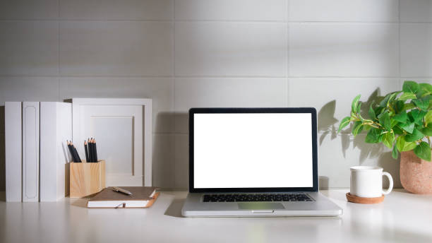 istock Laptop computer, coffee cup, potted plant and picture frame on creative workplace. Blank screen for your advertising text. 1679516055