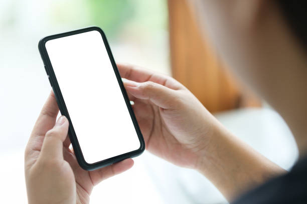 istock Mock up smartphone of hand holding black mobile phone with blank white screen. 1679517607